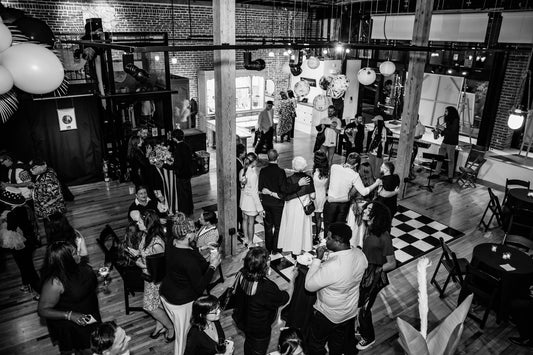Guests dressed in monochromatic attire at the Black and White Art Party, held at Sparks Gallery, a premier art gallery downtown San Diego