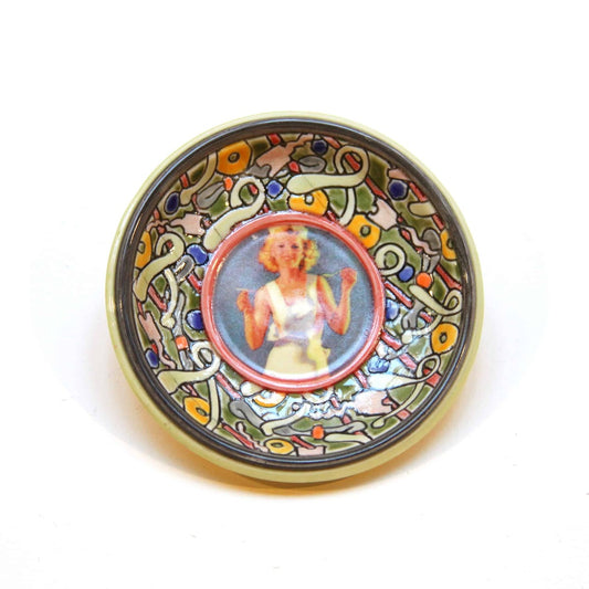 Woman in an Apron Hanging Plate