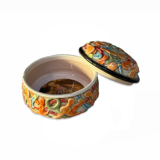 Orange Lidded Container With Clown Image Inside