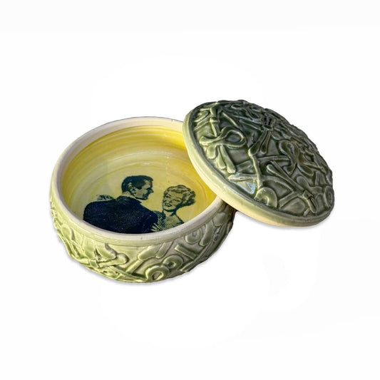 Green Lidded Container With Couple Image Inside